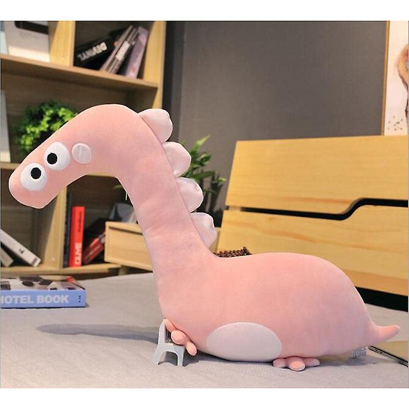 A cute pink dinosaur toy resting on a bed