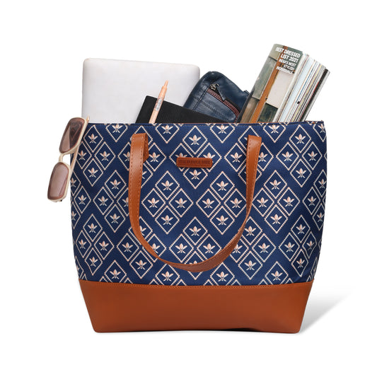 Tote bag in blue and brown hues by wooden chair