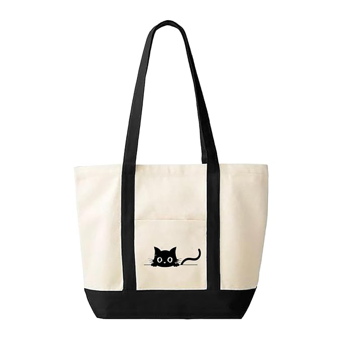 A sleek black cat sits proudly on the front of a stylish white tote bag.