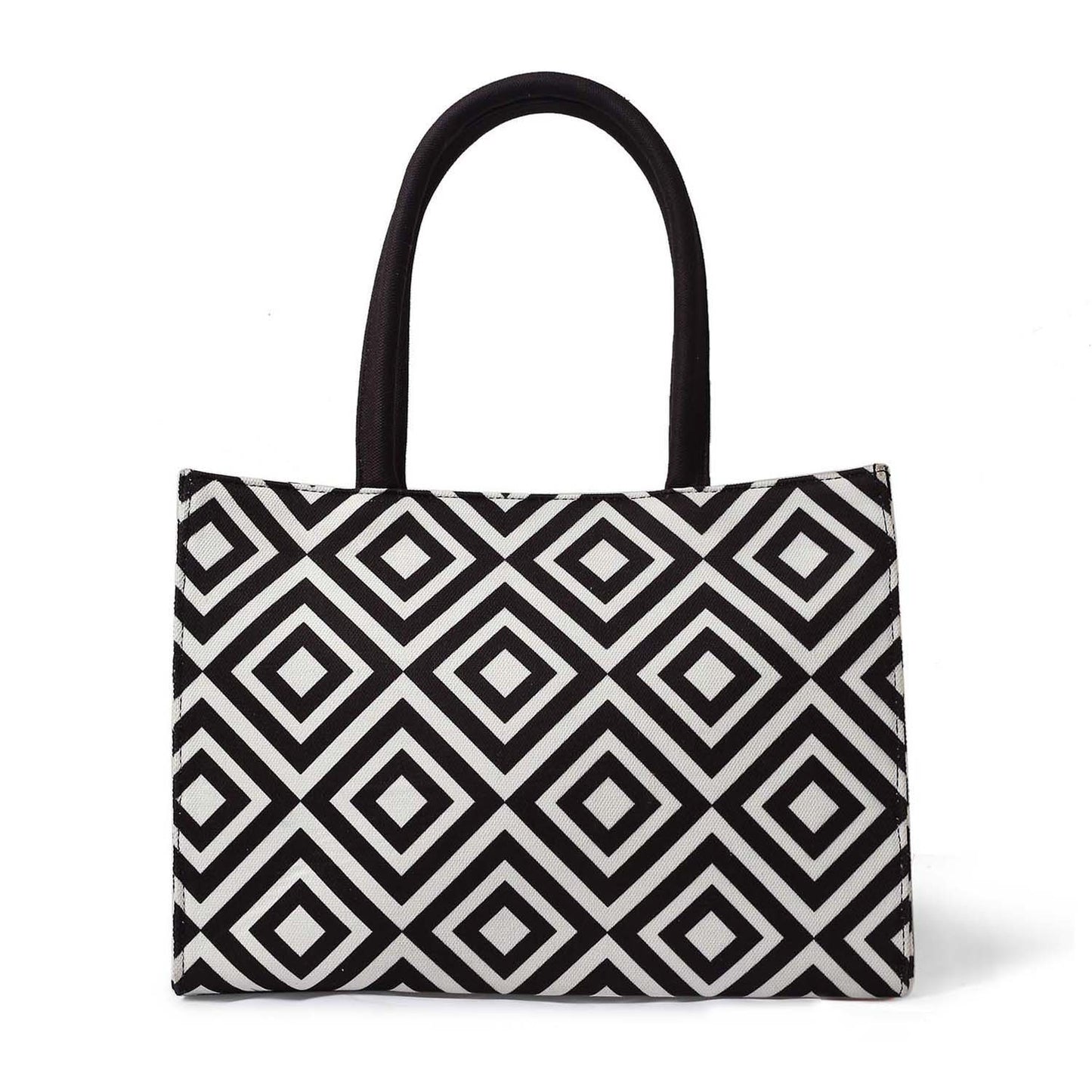 Fashionable bag in black and white pattern, with a book and glass of water.