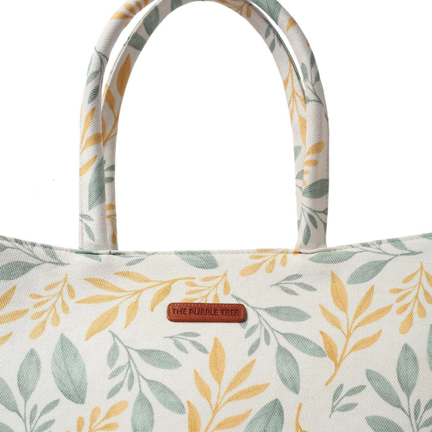Tote bag with a trendy yellow and green leaf pattern, ideal for everyday use.