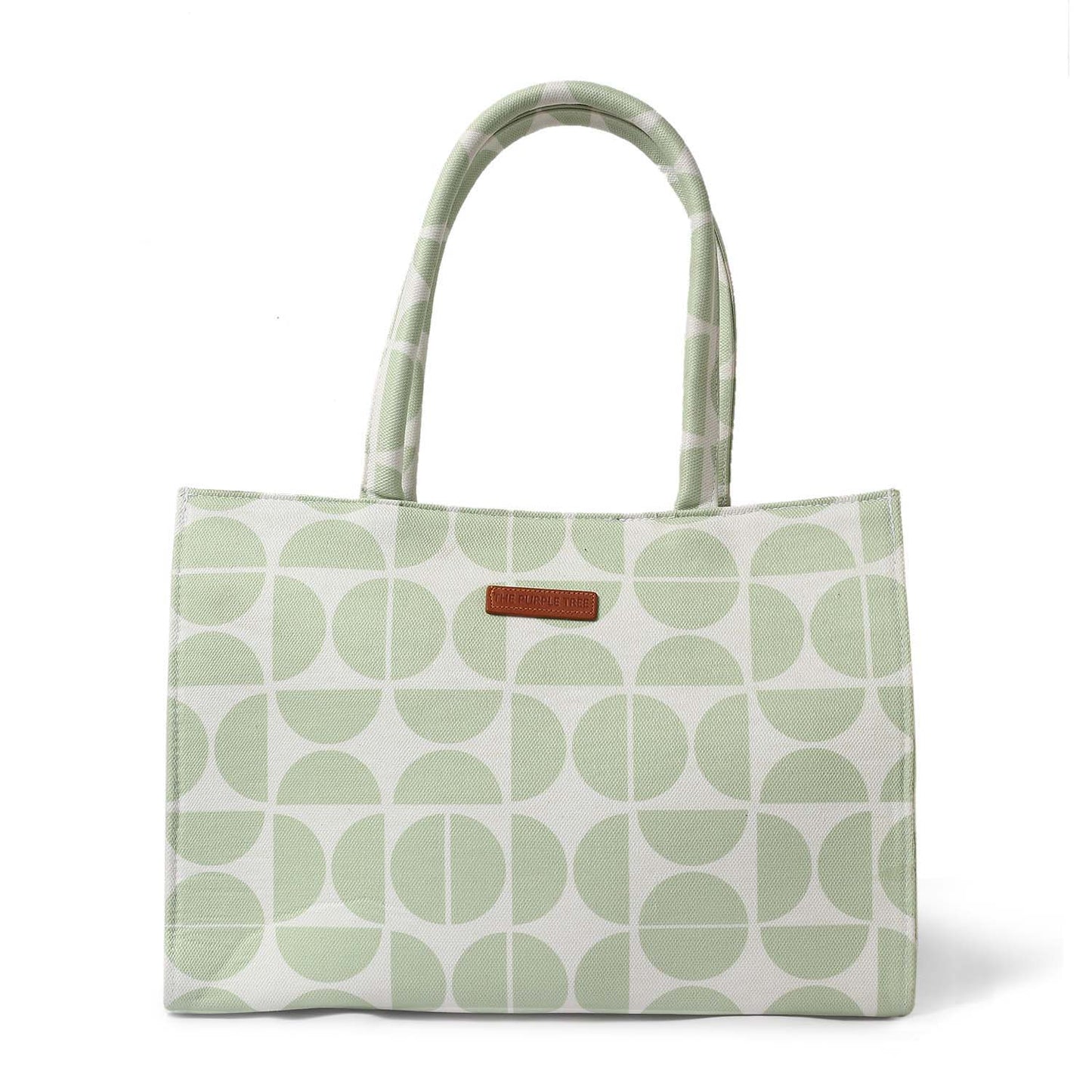 Tote bag in green and white with book and notebook inside.
