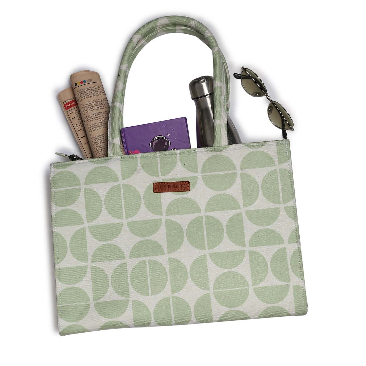 A stylish green and white tote bag with book and notebook.