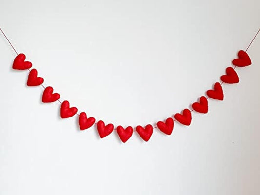 Heart-shaped garland decor on white wall.