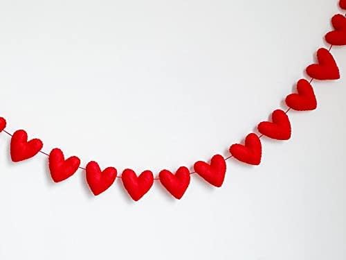 Red heart garland on white wall.
