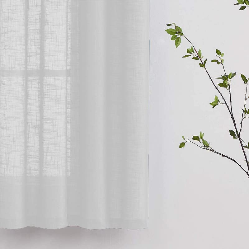 White linen curtains on a wooden table: a serene scene with elegant curtains cascading over a rustic table.