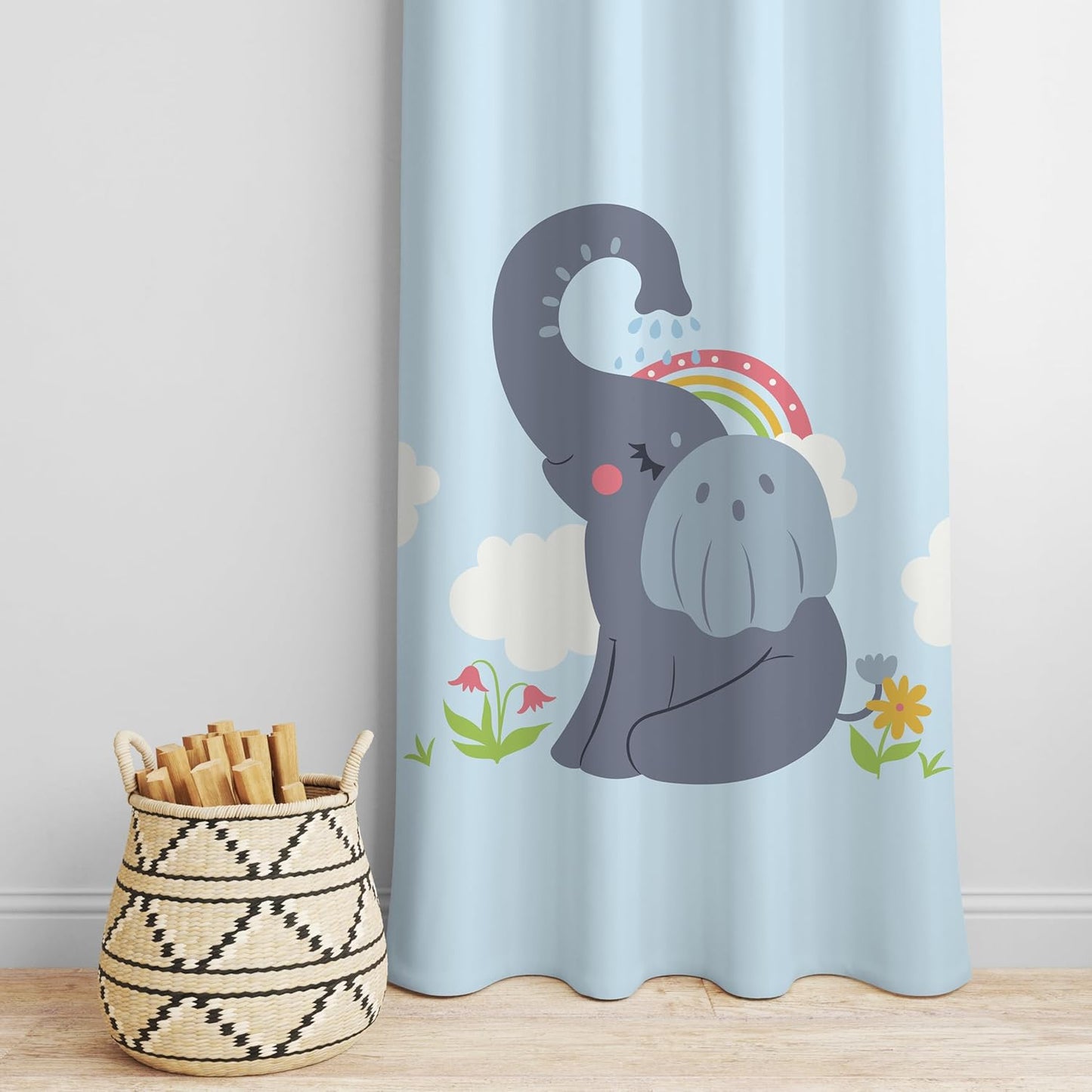A whimsical curtain depicting an elephant alongside a bright rainbow.