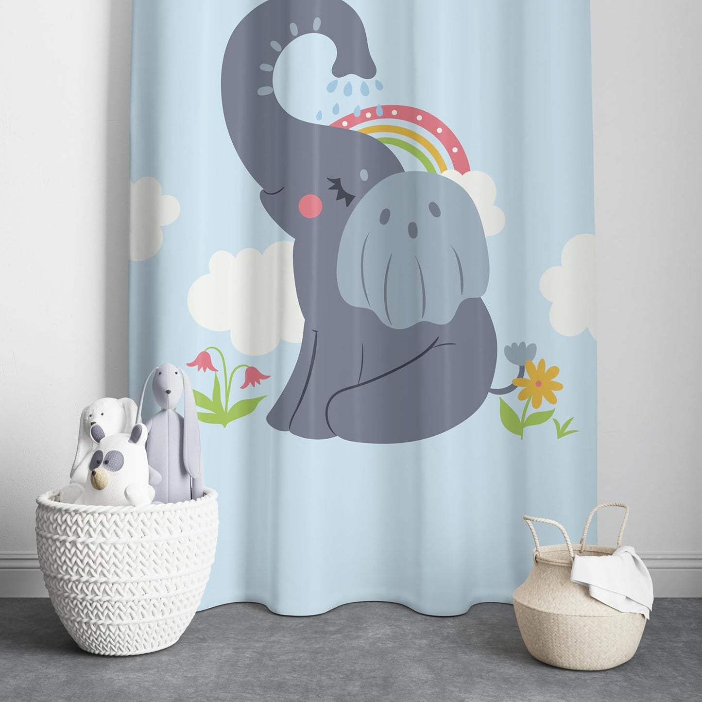 A colorful curtain featuring a playful elephant under a vibrant rainbow.