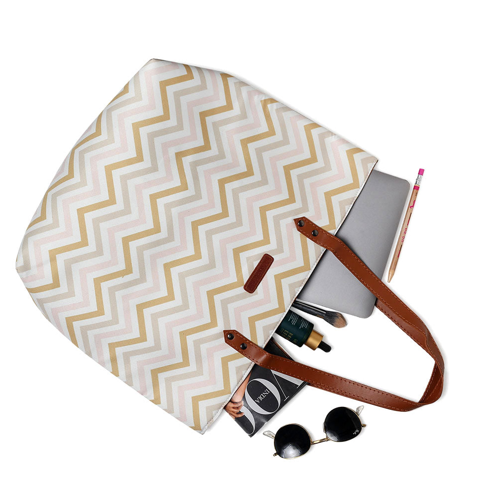 Eye-catching pink and gold chevron tote bag, a must-have accessory for any fashionista.