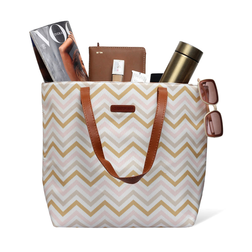 Stylish pink and gold chevron tote bag, perfect for adding a pop of color to your outfit.