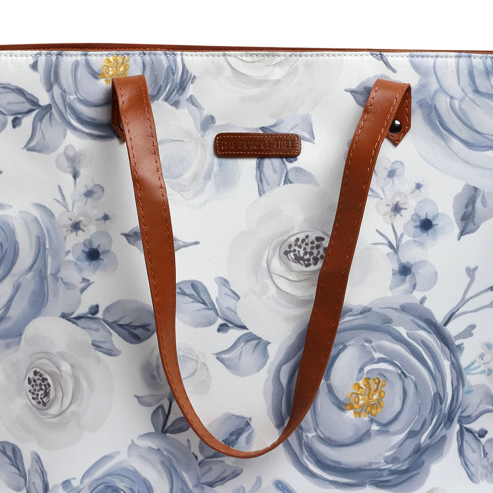 Stylish white and blue floral print tote bag, ideal for everyday use.