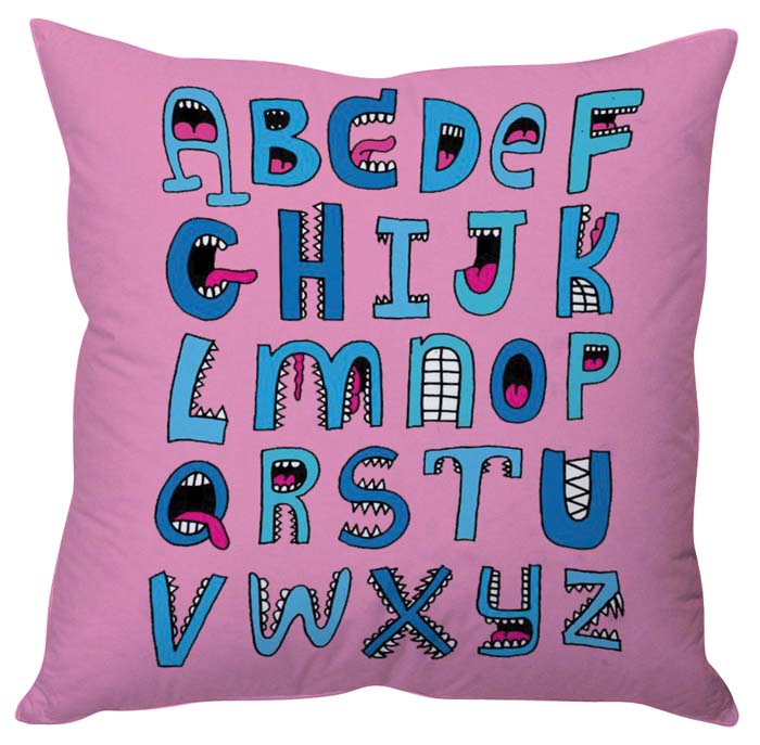 Pink pillow with colorful cartoon alphabet design, perfect for kids' room decor.