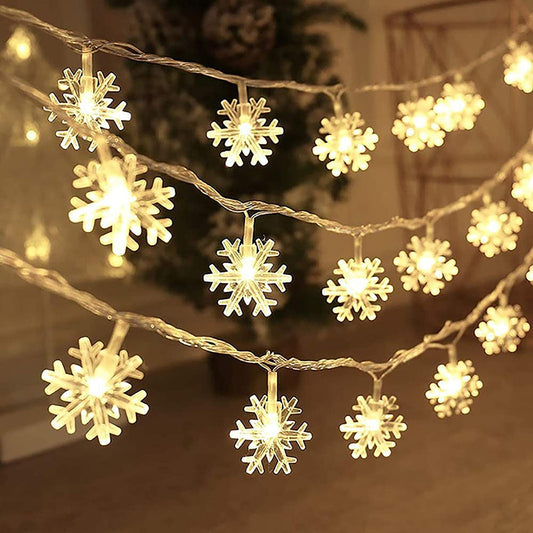 Snowflake LED Christmas lights shining brightly in the winter night.