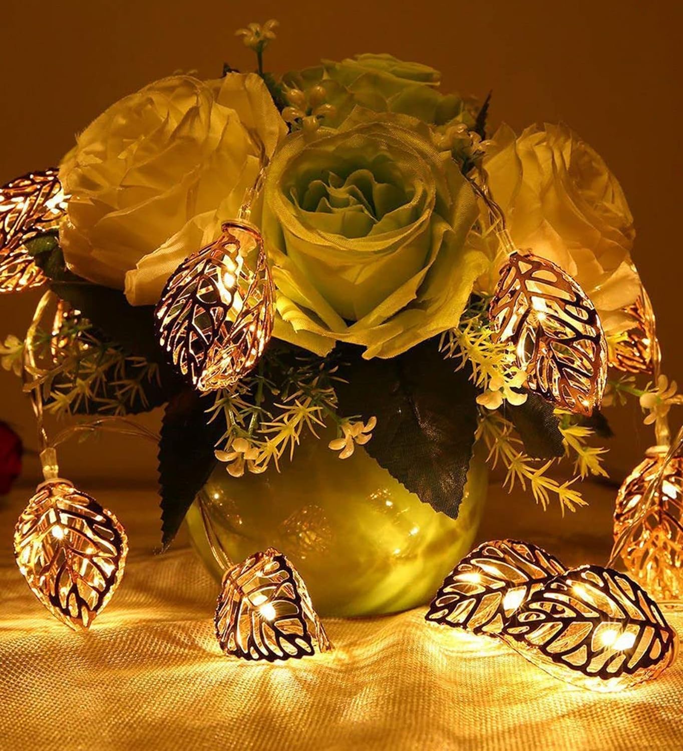 A vase filled with colorful flowers and twinkling lights, creating a magical and enchanting display.