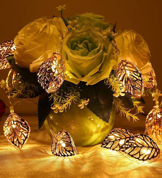 A vase filled with colorful flowers and twinkling lights, creating a magical and enchanting display.