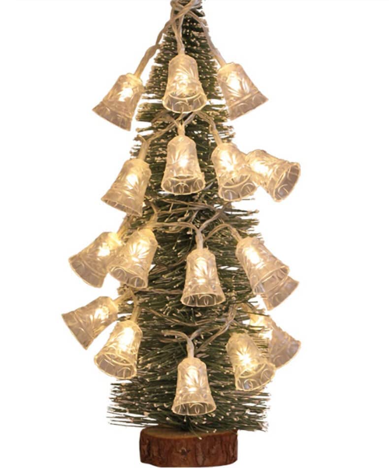 A festive Christmas tree adorned with a bell on top.