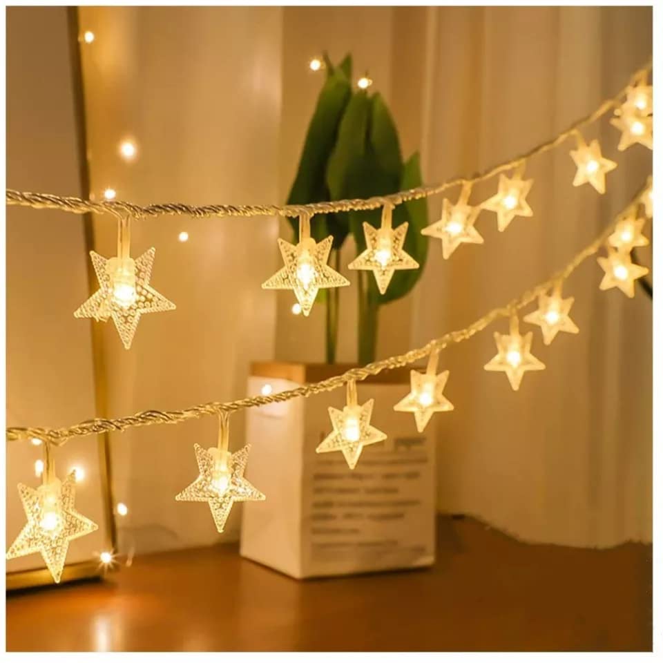 String of star lights glowing in the dark, perfect for adding a magical touch to any room decor.