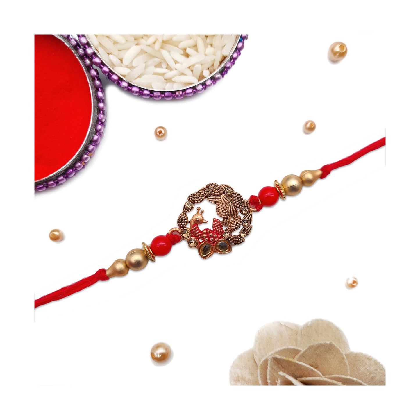 Traditional rakhi with red and gold thread, adorned with a shiny gold bead.