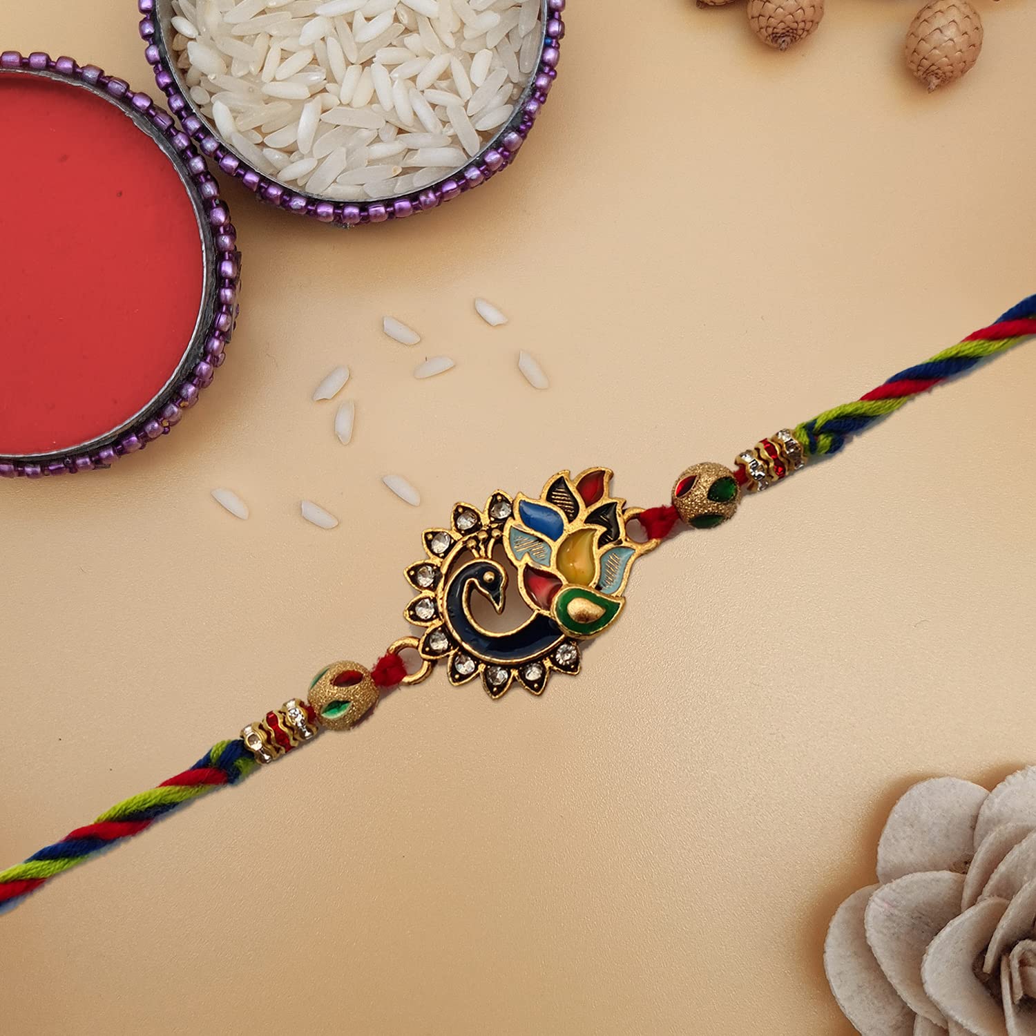Rakhi adorned with a striking gold and red pattern.