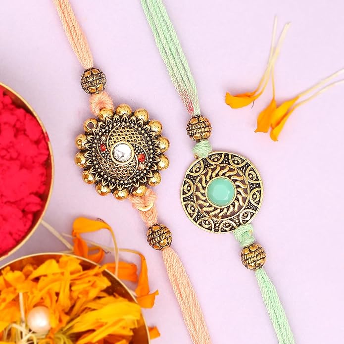 Two rakhi featuring intricate gold and green threads, symbolizing love and protection between siblings.