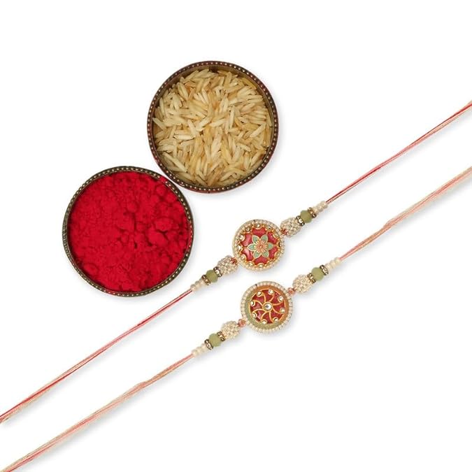 Two rakhi with pink and green beads, symbolizing love and protection, placed next to red powder and a bowl of rice.