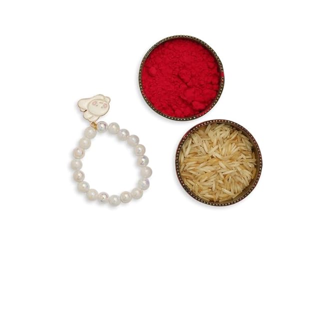 Red powder and white rakhi with pearl next to bowl of rice