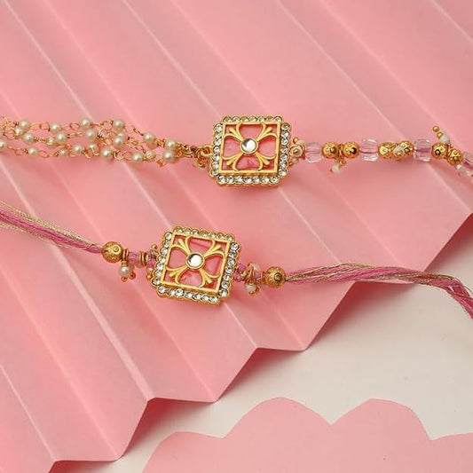 Two pink rakhi's with gold and pearl beads, perfect for celebrating Raksha Bandhan.