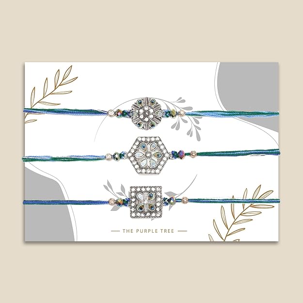 Trio of rakhi bracelets adorned with blue and white stones, ideal for Raksha Bandhan.