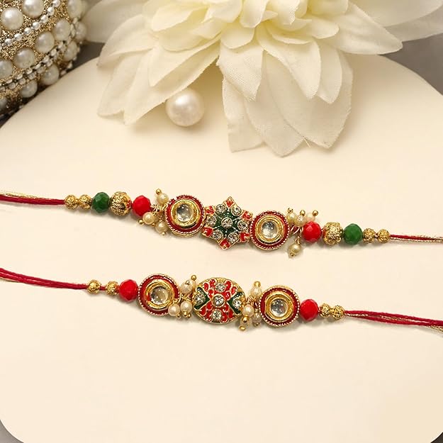 Pair of red and green rakhi adorned with colorful beads, representing a bond of love and protection.