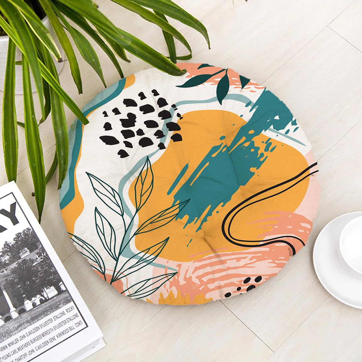 A vibrant round floor mat featuring a potted plant and an open book placed on it.