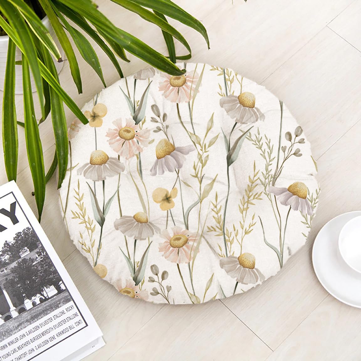 A round floor mat featuring a floral and leaf design in vibrant colors.