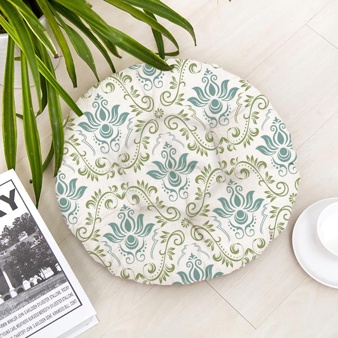 Round cushion featuring a green and white pattern, adding a decorative touch to any seating area.