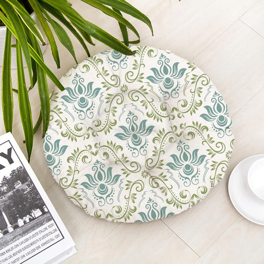 Round cushion featuring a green and white pattern, adding a decorative touch to any seating area.