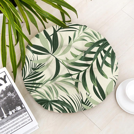 A round plate featuring a vibrant tropical leaf pattern, showcasing shades of green and hints of yellow.