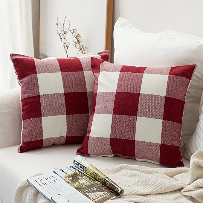 Two red and white checkered pillows resting on a cozy couch, adding a pop of color to the living room.