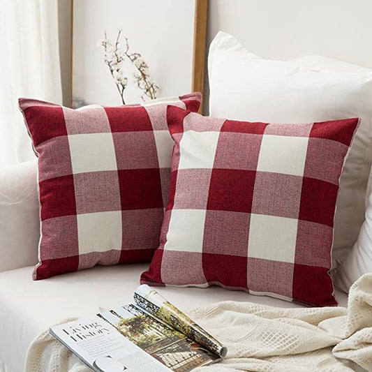 Two red and white checkered pillows resting on a cozy couch, adding a pop of color to the living room.