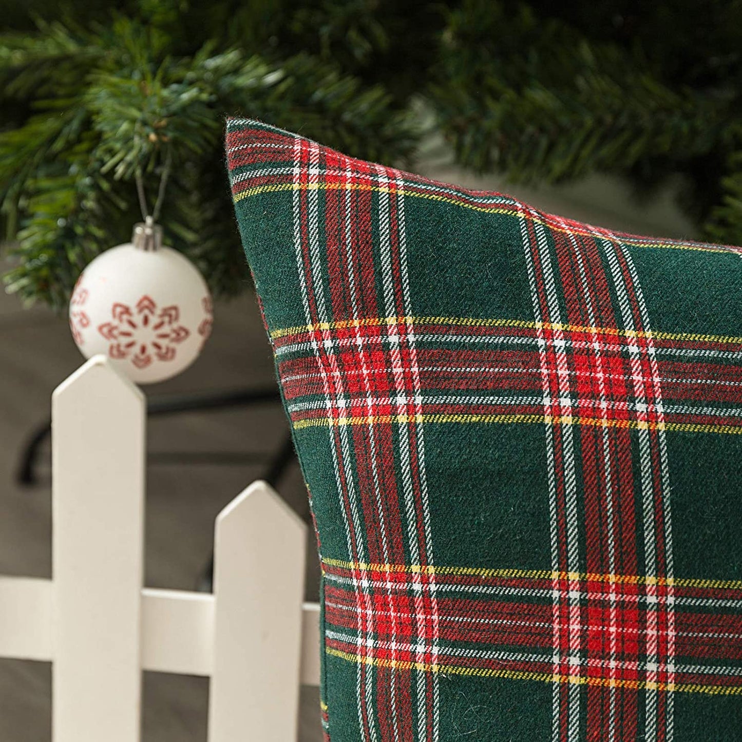 Two decorative pillows with trendy plaid patterns, ideal for snuggling up on the couch.