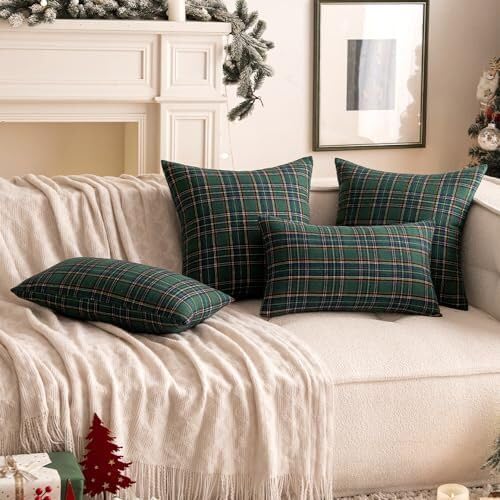 Two vibrant green plaid pillows accented with striking black and white stripes, ideal for a chic living room look.