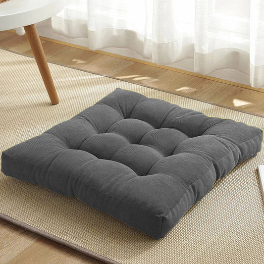 Gray cushion resting on rug.