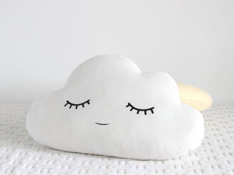 4. Cute pillows with cloud, star, and moon illustrations.