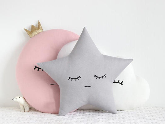 Three decorative pillows featuring a moon and cloud design, perfect for adding a touch of whimsy to any room.