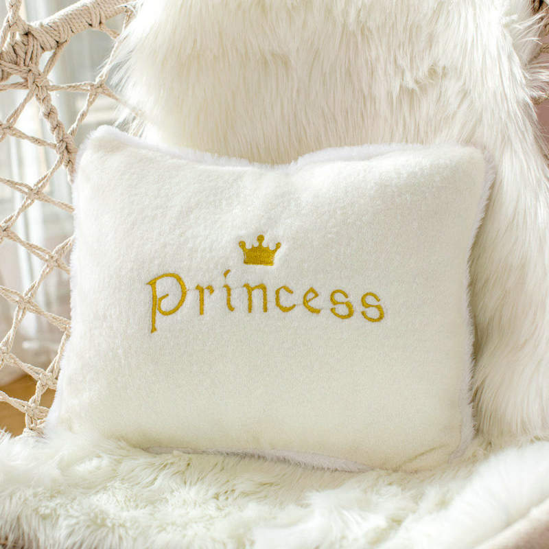 White pillow with "princess" in elegant cursive script.