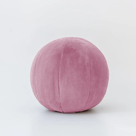 A vibrant assortment of balls scattered on a clean white floor, creating a playful and colorful scene.