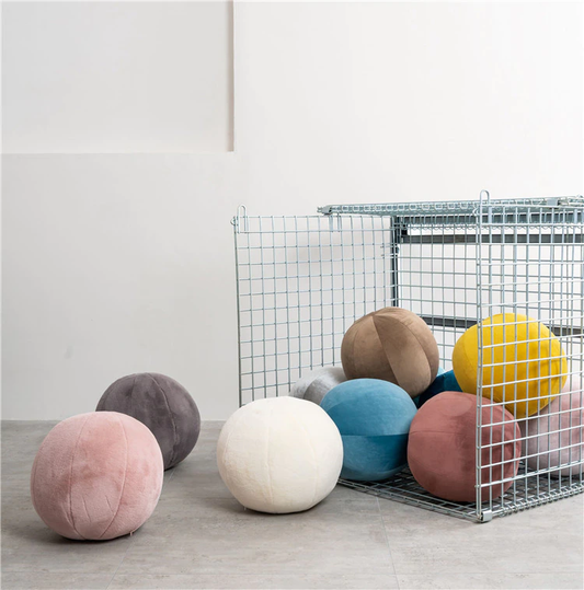 Colorful spheres on bright white floor.
