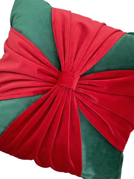 Vibrant green and red pillow adorned with a red bow, ideal for bringing a pop of color to any room.