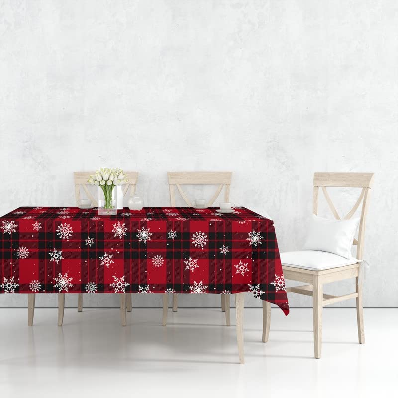 Festive red plaid tablecloth with snowflakes, perfect for Christmas gatherings.