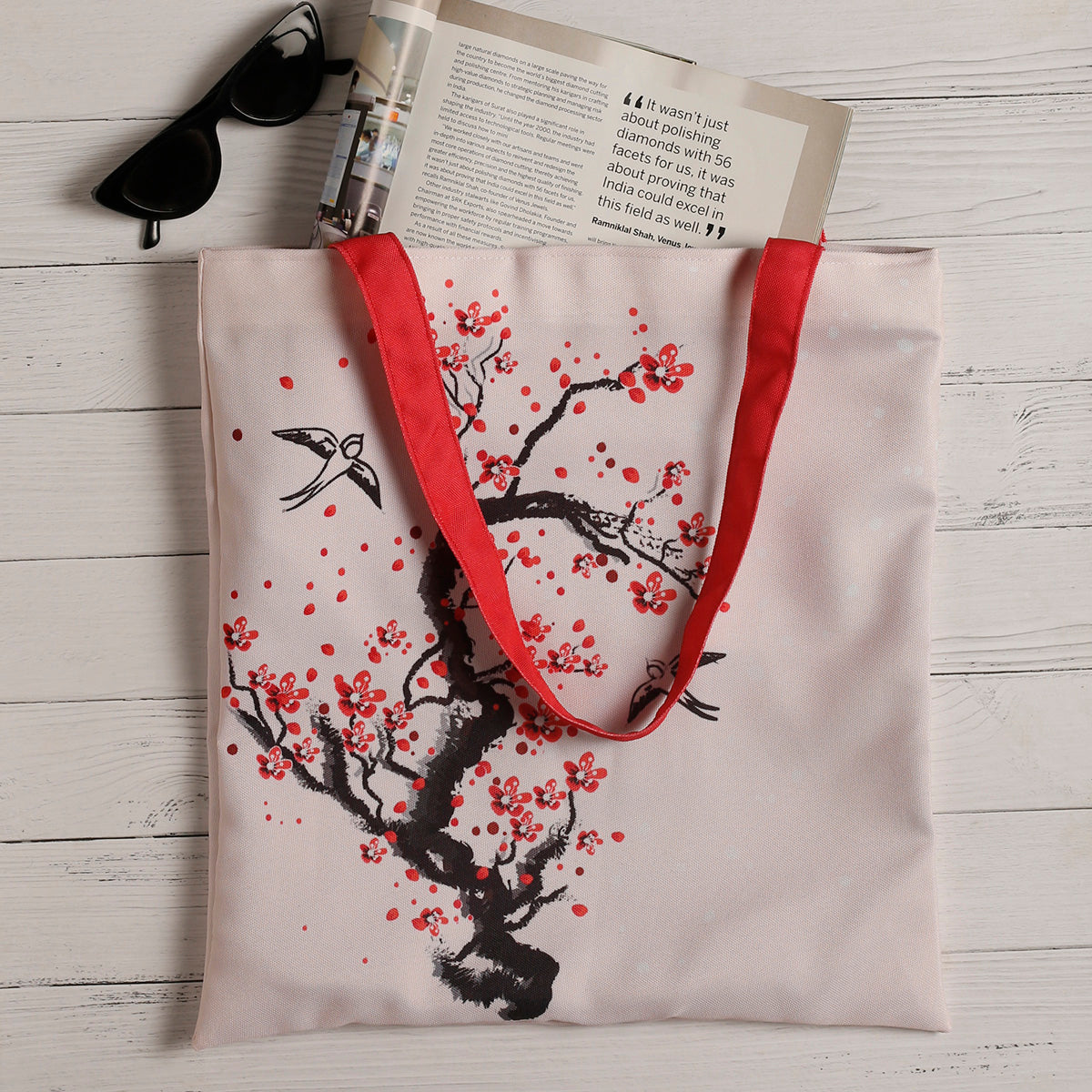 Chic tote bag adorned with delicate cherry blossoms, ideal for adding a touch of elegance to your outfit.