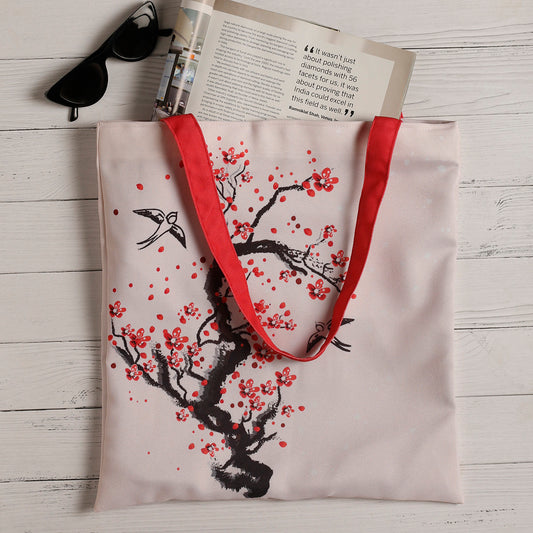Chic tote bag adorned with delicate cherry blossoms, ideal for adding a touch of elegance to your outfit.