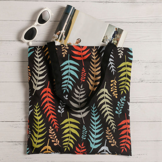A vibrant tote bag with sunglasses and a fern leaf design, perfect for adding a pop of color to your outfit.