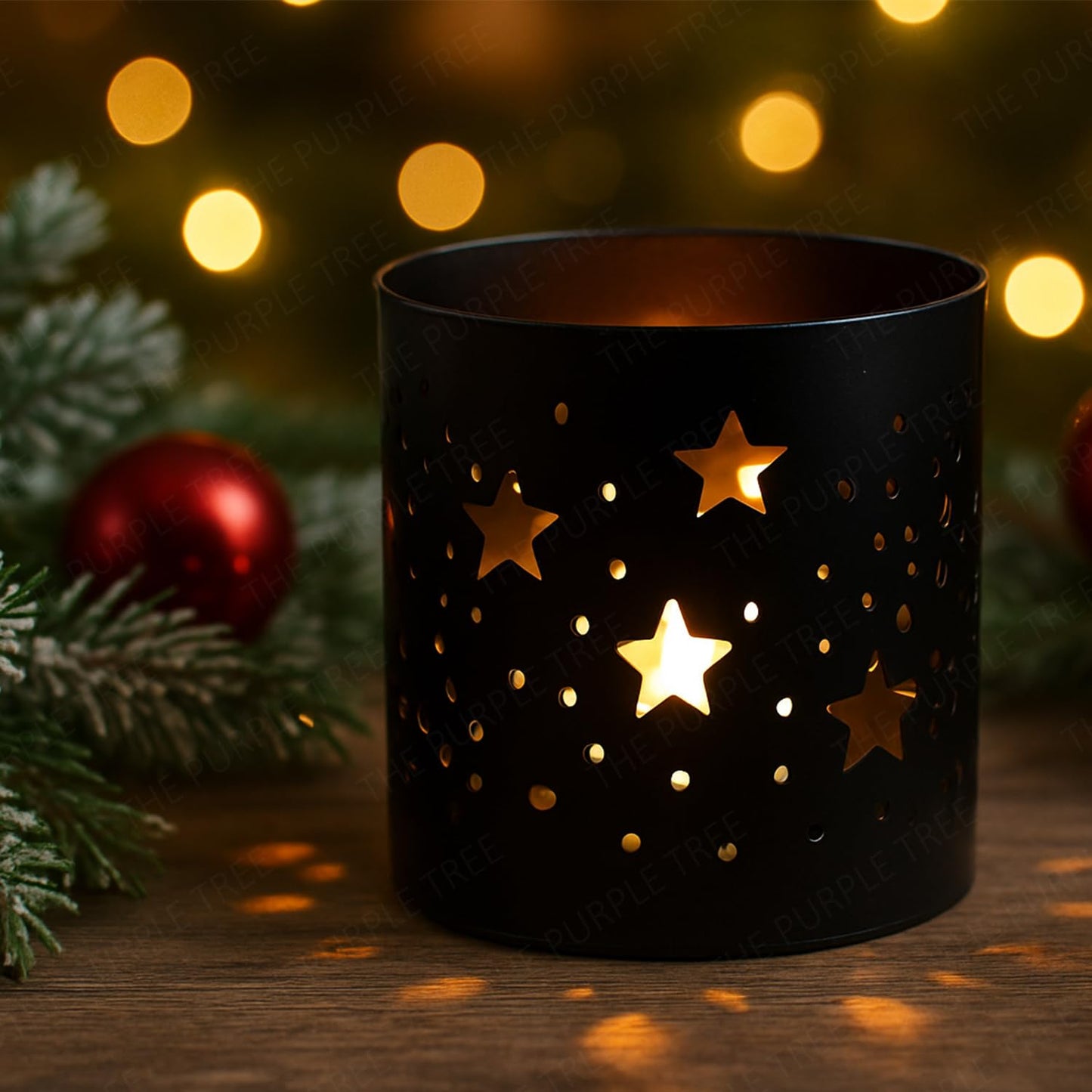 Black candle holder with star designs on a wooden surface with Christmas decorations.